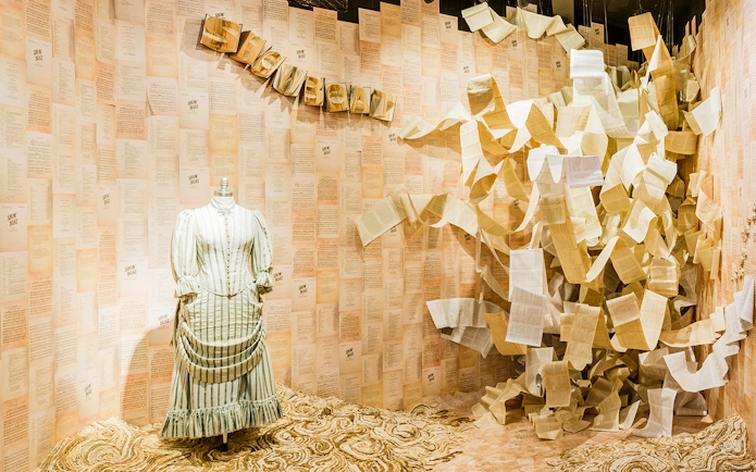 Mannequin in period costume with "Show Boat" script pages at Museum of Broadway exhibit.