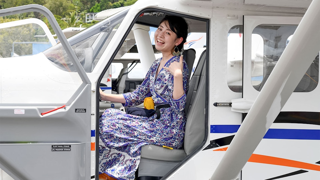 Woman seated in plane for scenic flight to Outer Edges of Great Barrier Reef.