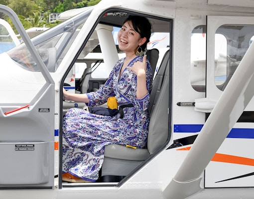 Woman seated in plane for scenic flight to Outer Edges of Great Barrier Reef.