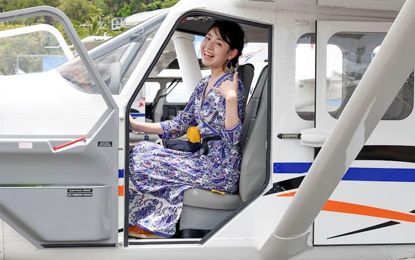 Woman seated in plane for scenic flight to Outer Edges of Great Barrier Reef.