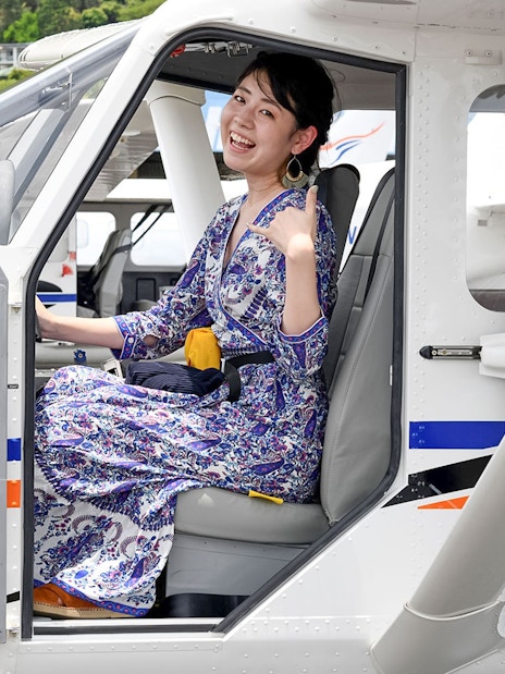 Woman seated in plane for scenic flight to Outer Edges of Great Barrier Reef.