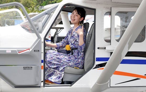 Woman seated in plane for scenic flight to Outer Edges of Great Barrier Reef.