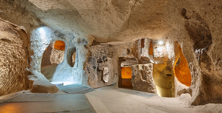 Maze of caves in Derinkuyu Underground City, Cappadocia, with illuminated passageways.