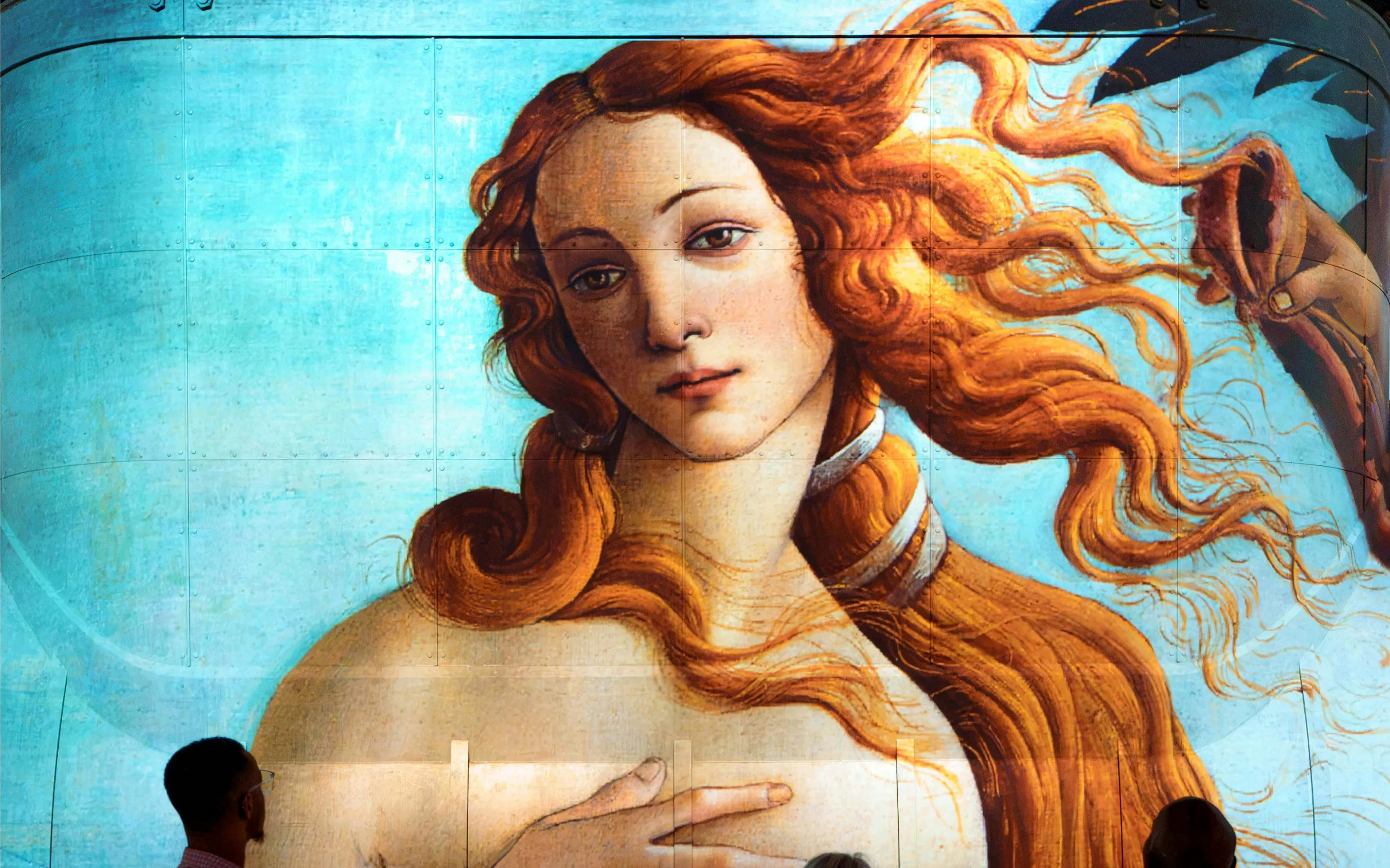 Botticelli's Birth of Venus mural with visitors viewing in Florence, Italy.