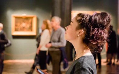 Visitor observing artwork at Prague National Museum exhibit.