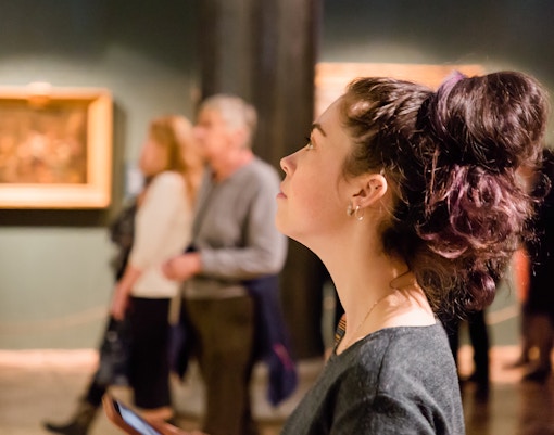 Visitor observing artwork at Prague National Museum exhibit.
