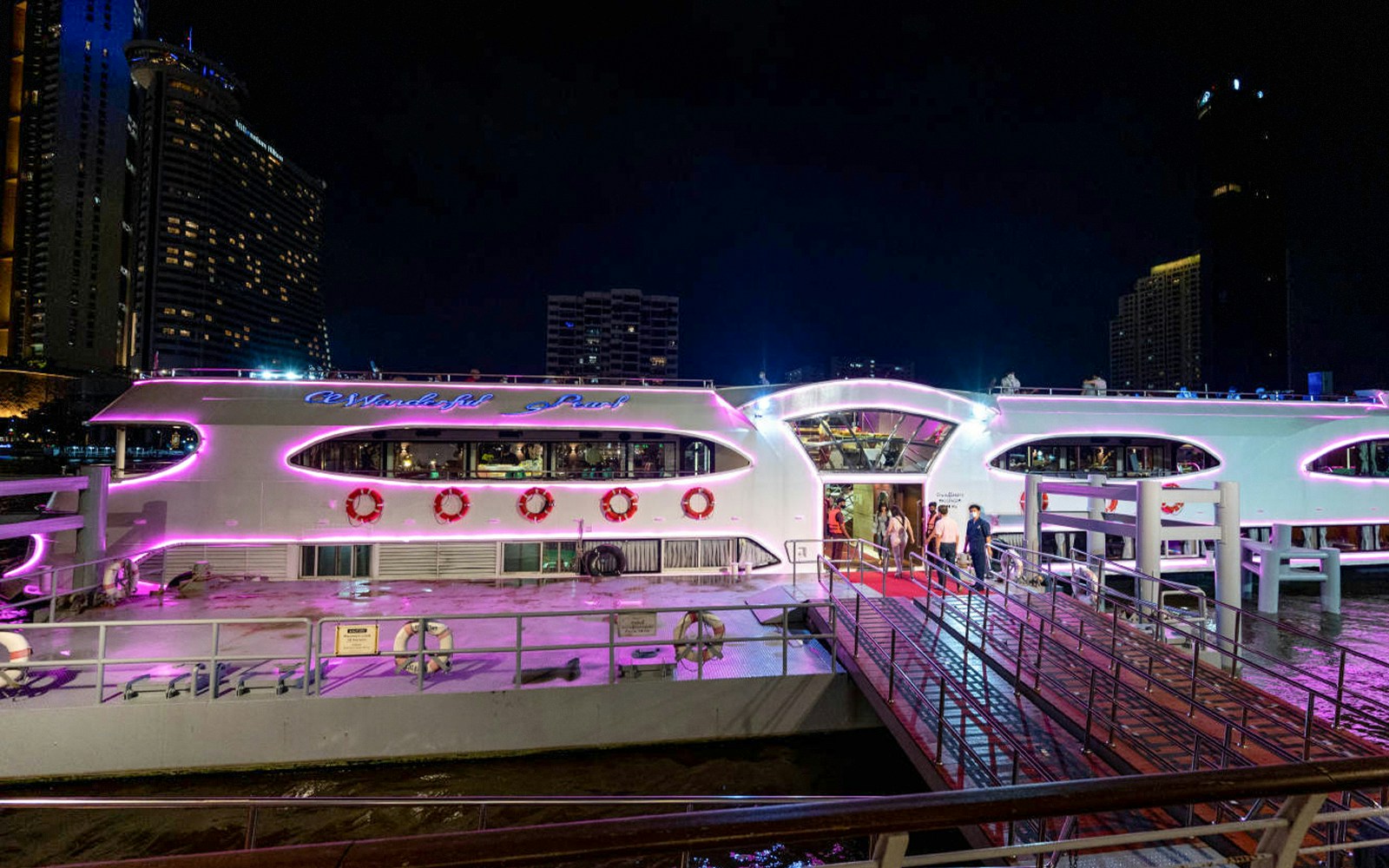 People boarding Wonderful Pearl Luxury Cruise in Bangkok for a 5-star dinner experience.