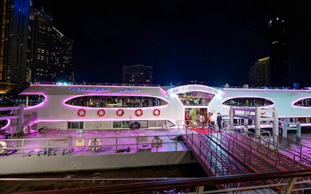 People boarding Wonderful Pearl Luxury Cruise at night.
