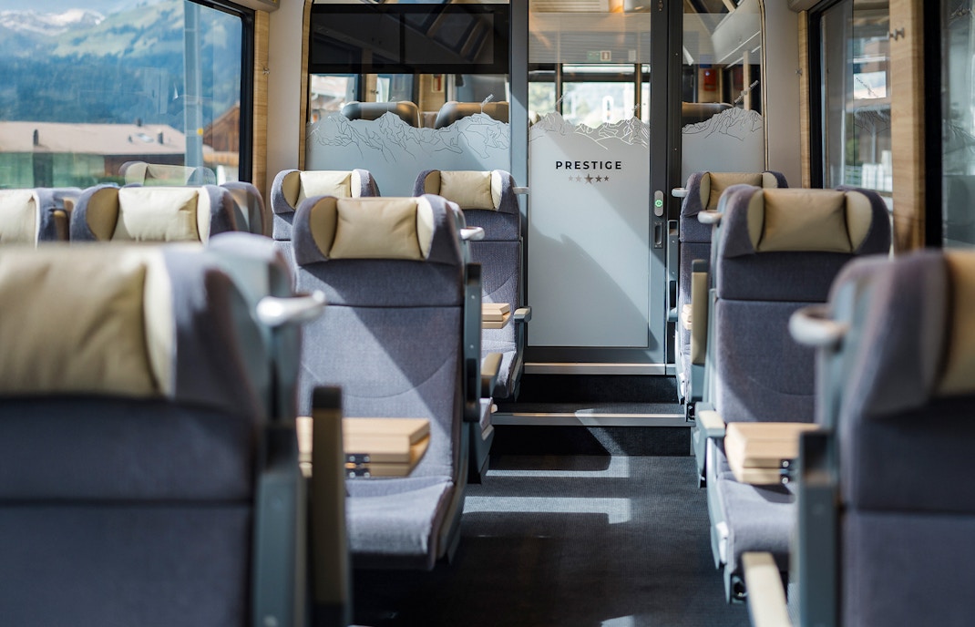 First Class on Golden Pass train with panoramic views of Swiss Alps.