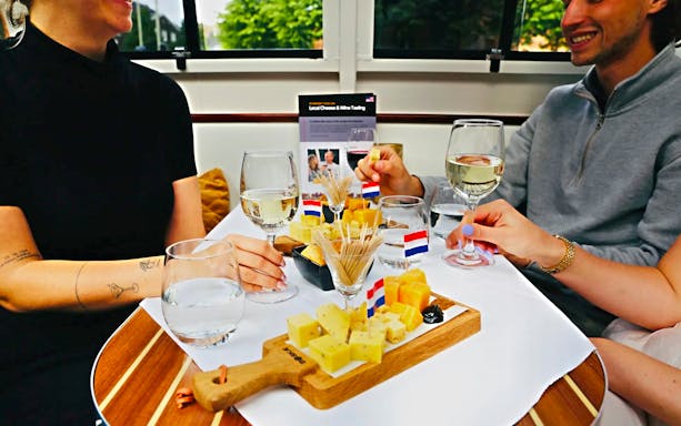 Cheese and wine tasting on a Haarlem cruise with Dutch flags on the table.
