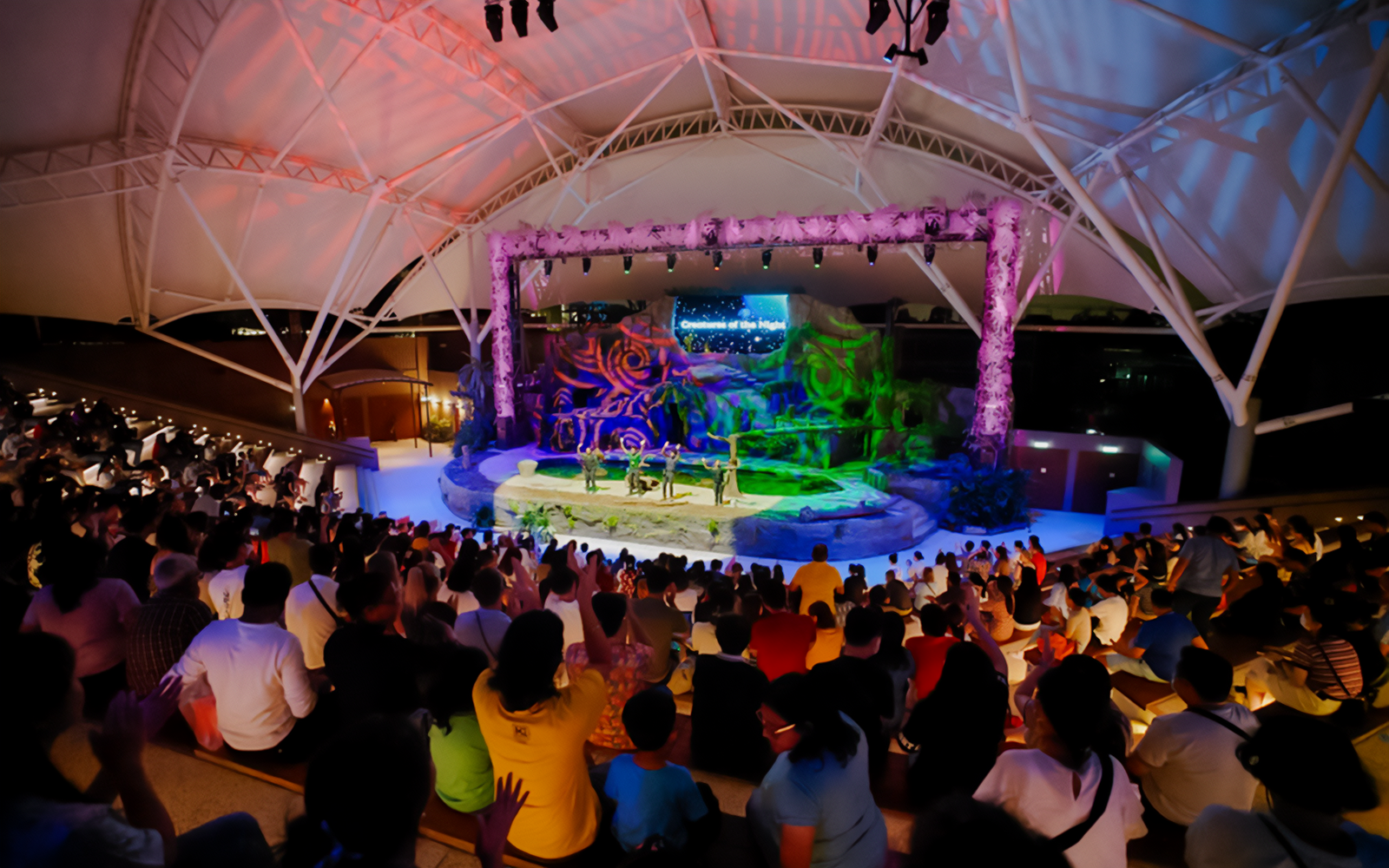 Audience watching Creature of the Night presentation at an amphitheater.