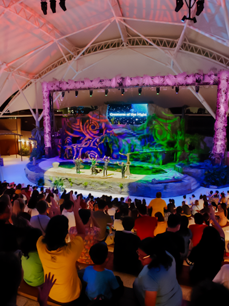 Audience watching Creature of the Night presentation at an amphitheater.