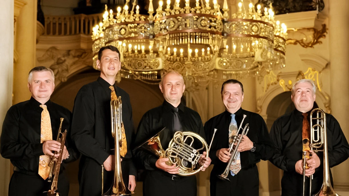 Musicians with brass instruments at St. Nicholas Church concert in Prague.