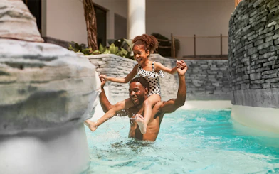 Father and child enjoying pool at Bellewaerde Aquapark, Belgium.