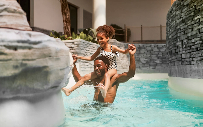Father and child enjoying pool at Bellewaerde Aquapark, Belgium.