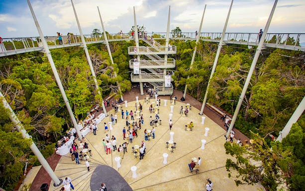 Guests at Habitat Penang Hill exploring canopy walk and central plaza.