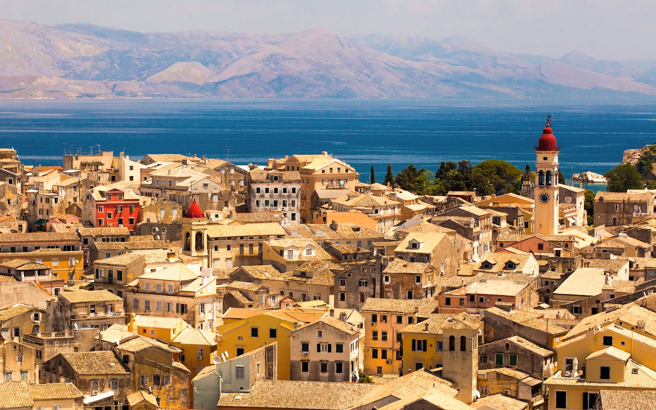 Aerial view of Corfu town with historic buildings and a clock tower, Kerkyra, Greece.