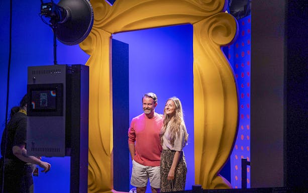 Visitors posing in front of the iconic yellow frame at The FRIENDS VIP Experience.