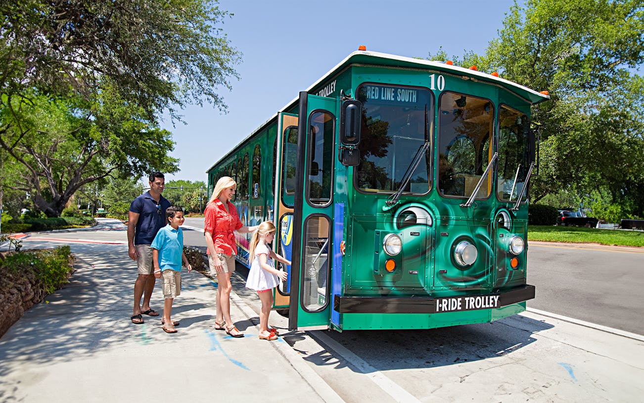 Family boarding I-Ride Trolley on Orlando Hop-On Hop-Off tour.