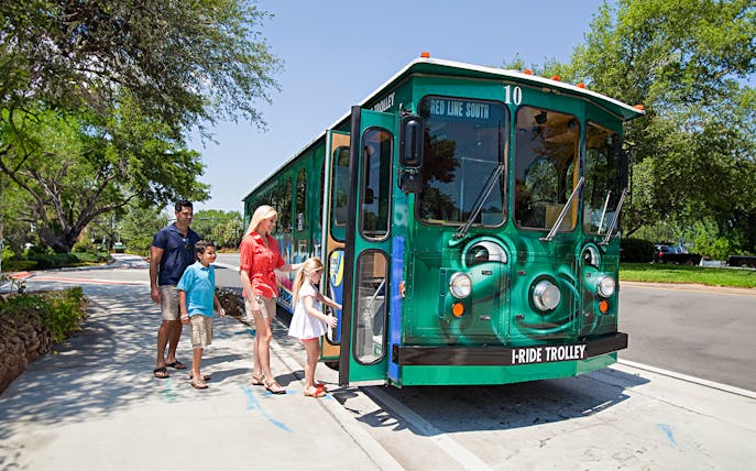 Family boarding I-Ride Trolley on Orlando Hop-On Hop-Off tour.