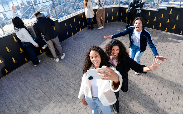 Visitors taking a selfie on the Empire State Building observation deck.