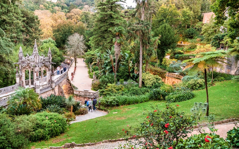 Quinta da Regaleira garden path with stone steps and lush greenery, Sintra, Portugal.