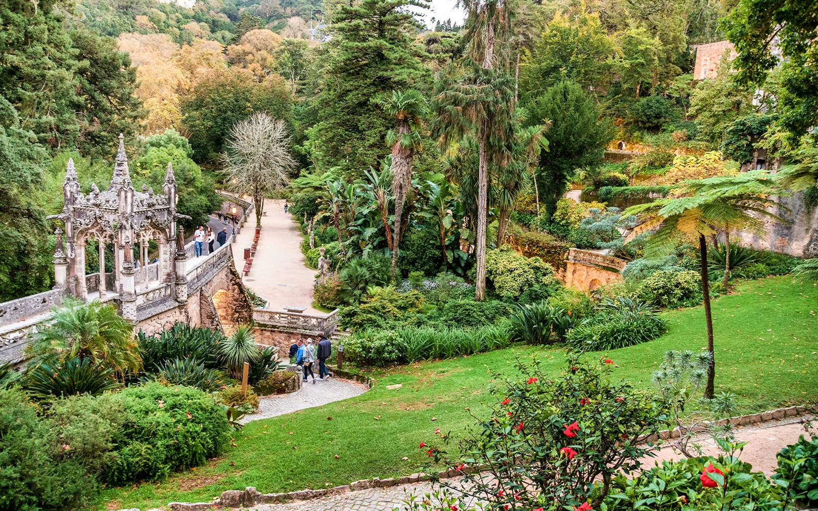 Quinta da Regaleira garden path with stone steps and lush greenery, Sintra, Portugal.