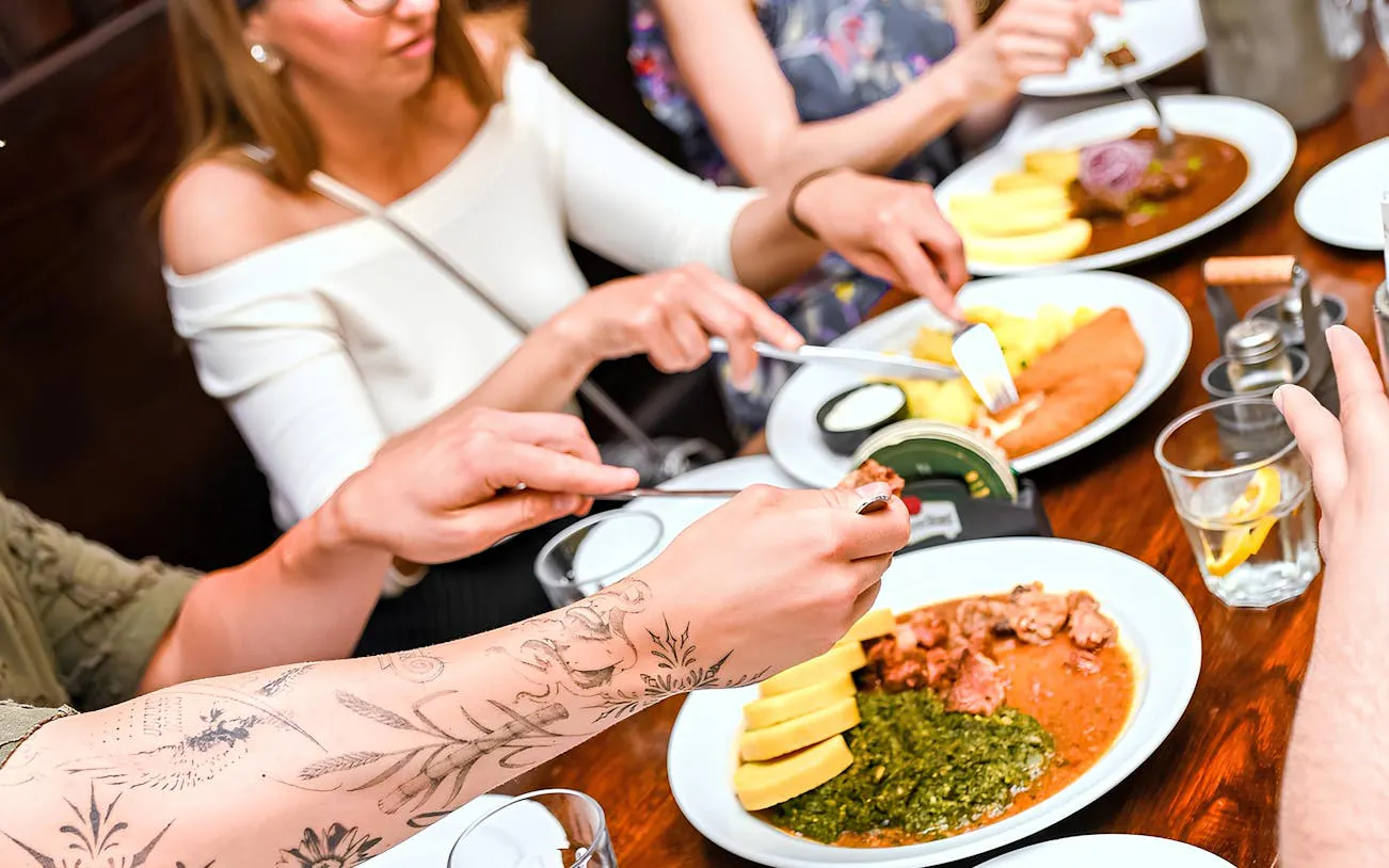 Dining on traditional Czech dishes during Prague food tour.