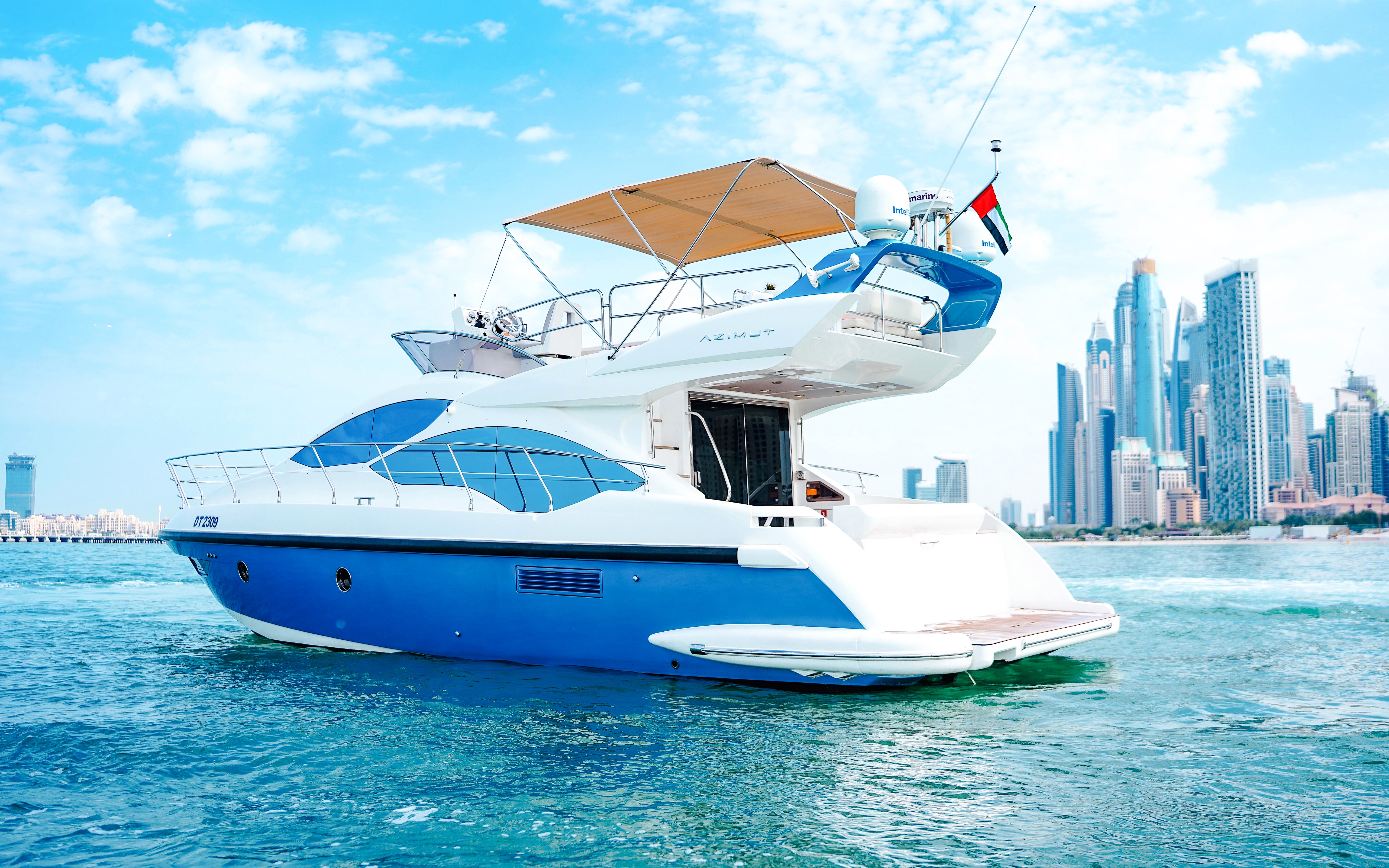 Private luxury yacht cruising near Dubai skyline.