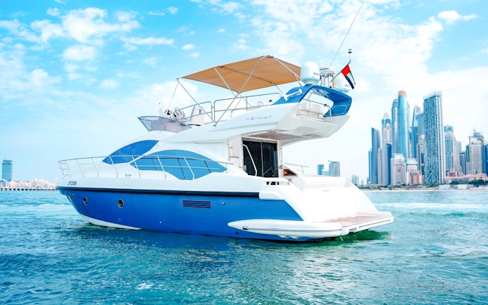 Private luxury yacht cruising near Dubai skyline.