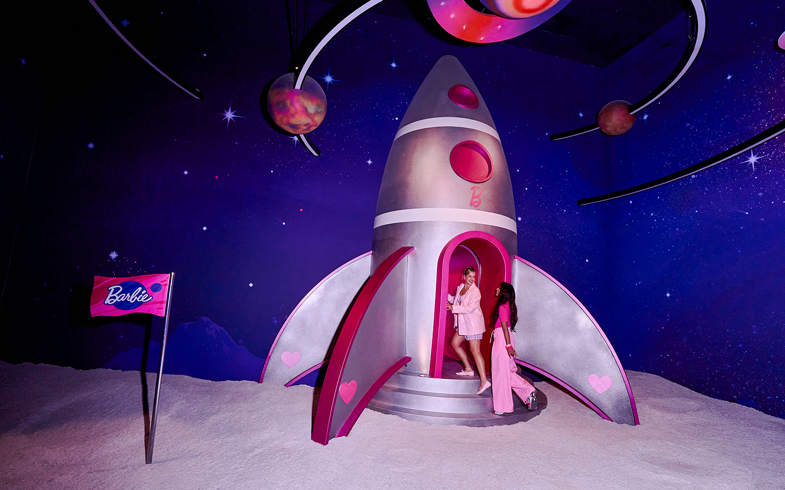 Guests exploring a Barbie-themed rocket at The Dream Experience in Amsterdam.