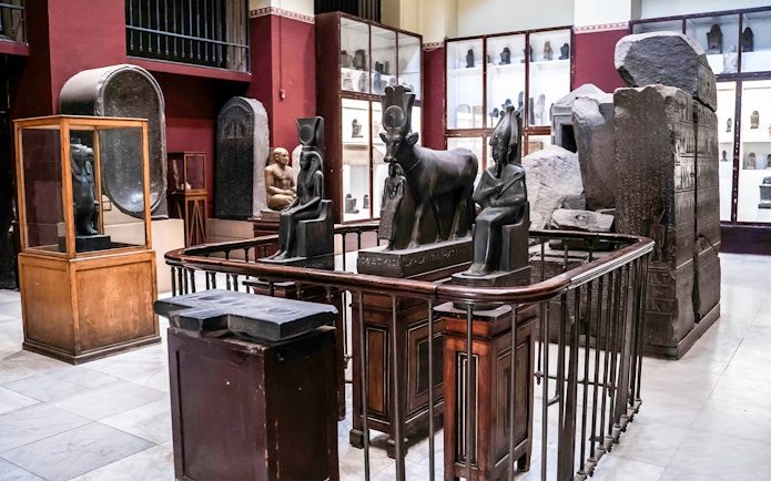 Ancient Egyptian statues and artefacts displayed in the Grand Egyptian Museum.