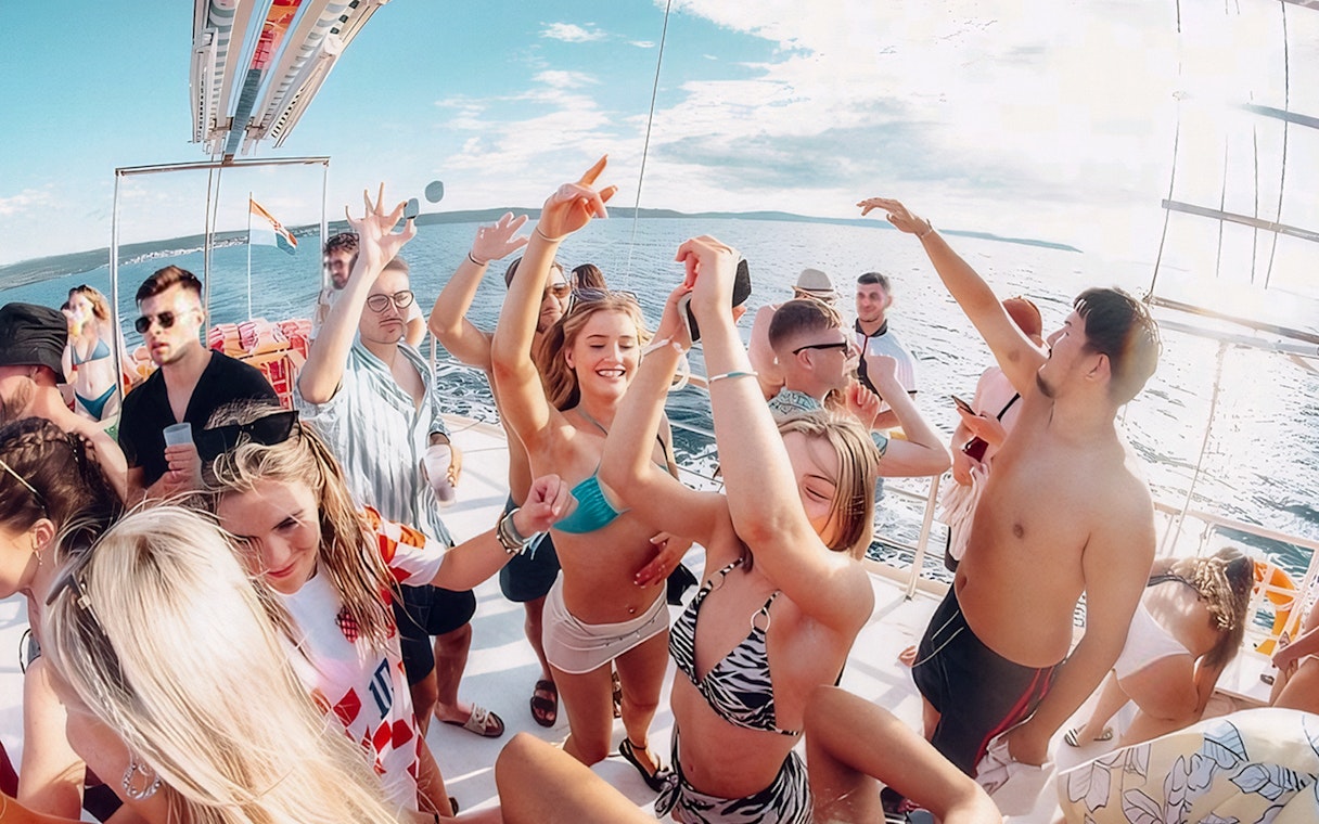 Guests dancing and enjoying the Split Party Cruise on a boat in the Adriatic Sea.