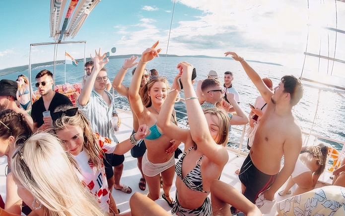 Guests dancing and enjoying the Split Party Cruise on a boat in the Adriatic Sea.