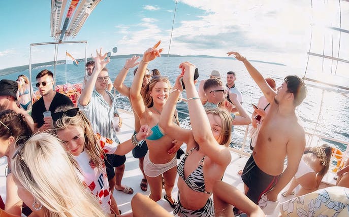 Guests dancing and enjoying the Split Party Cruise on a boat in the Adriatic Sea.