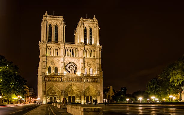Notre-Dame Cathedral illuminated at night, Paris city tour.