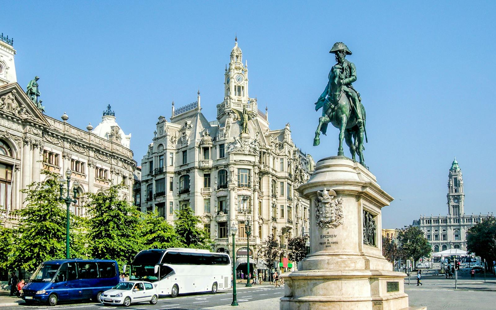 Statue of Dom Pedro IV on horseback in Porto's Avenida dos Aliados with historic buildings.
