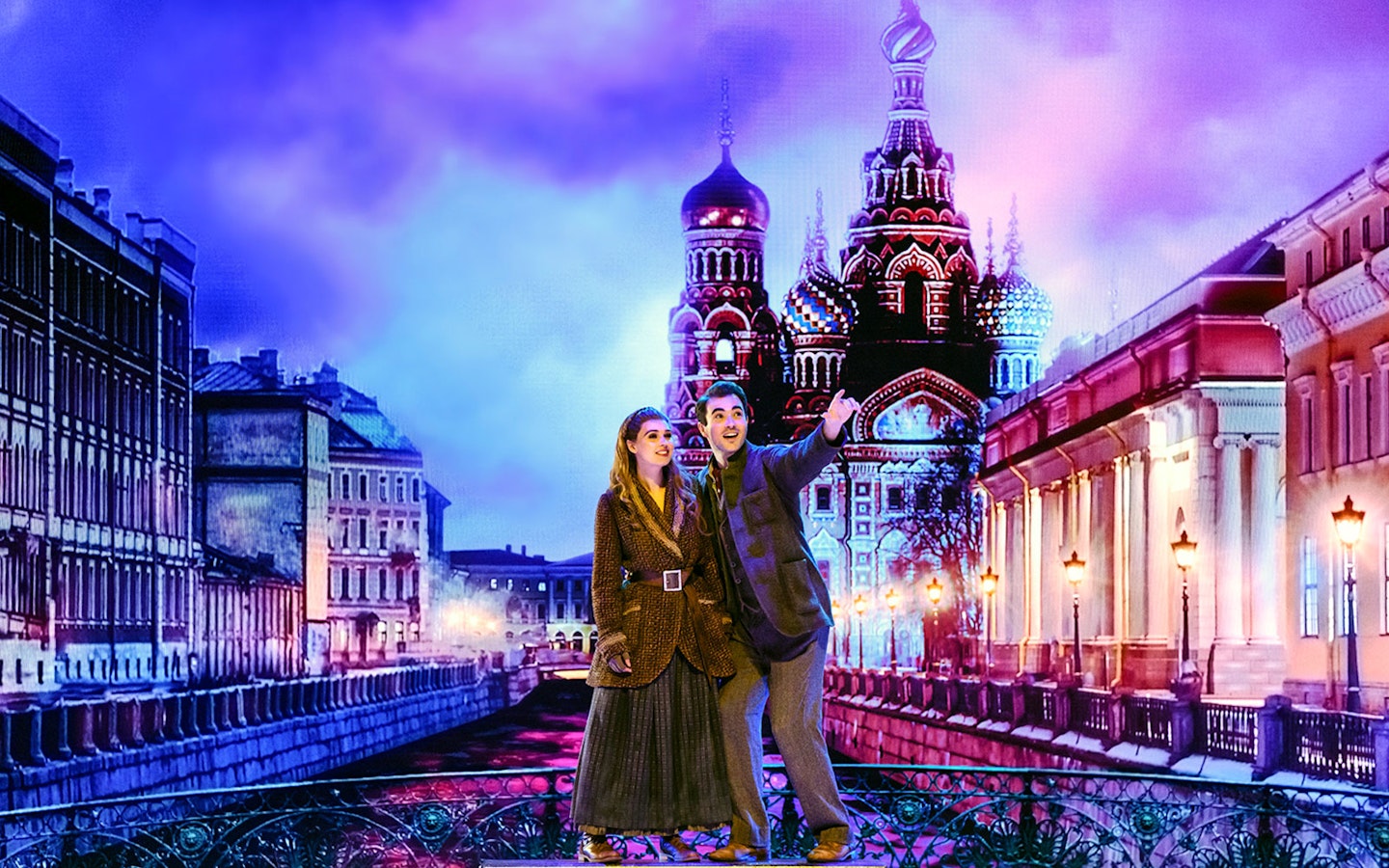 Two actors performing in front of a backdrop of St. Petersburg's Church of the Savior on Spilled Blood.