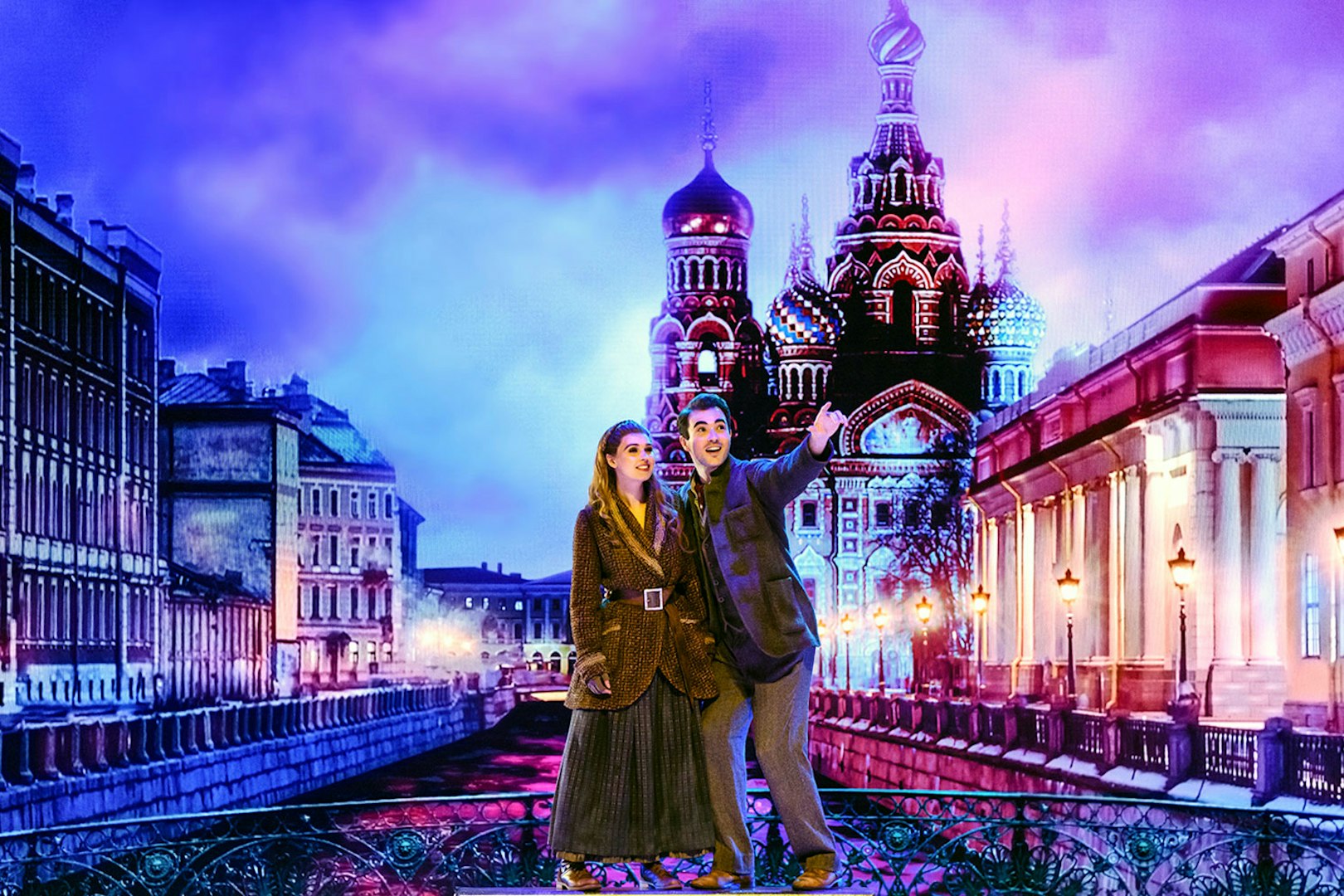 Two actors performing in front of a backdrop of St. Petersburg's Church of the Savior on Spilled Blood.
