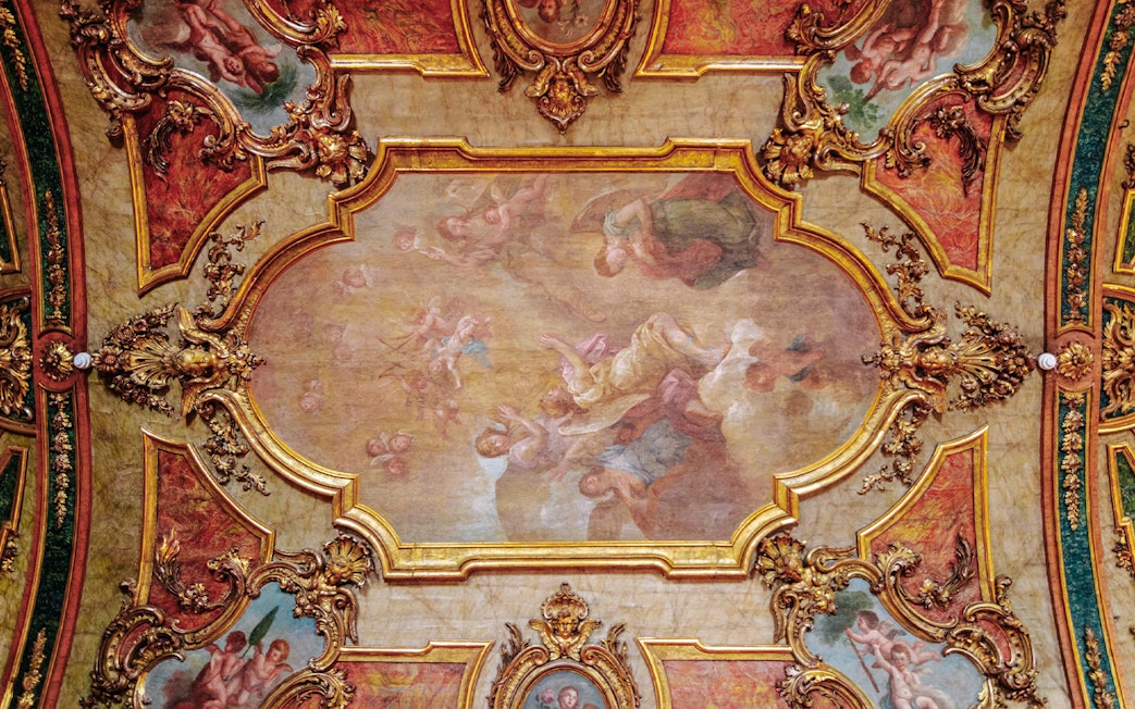 National Palace of Queluz Chapel ceiling artwork with ornate gold framing and angelic figures.