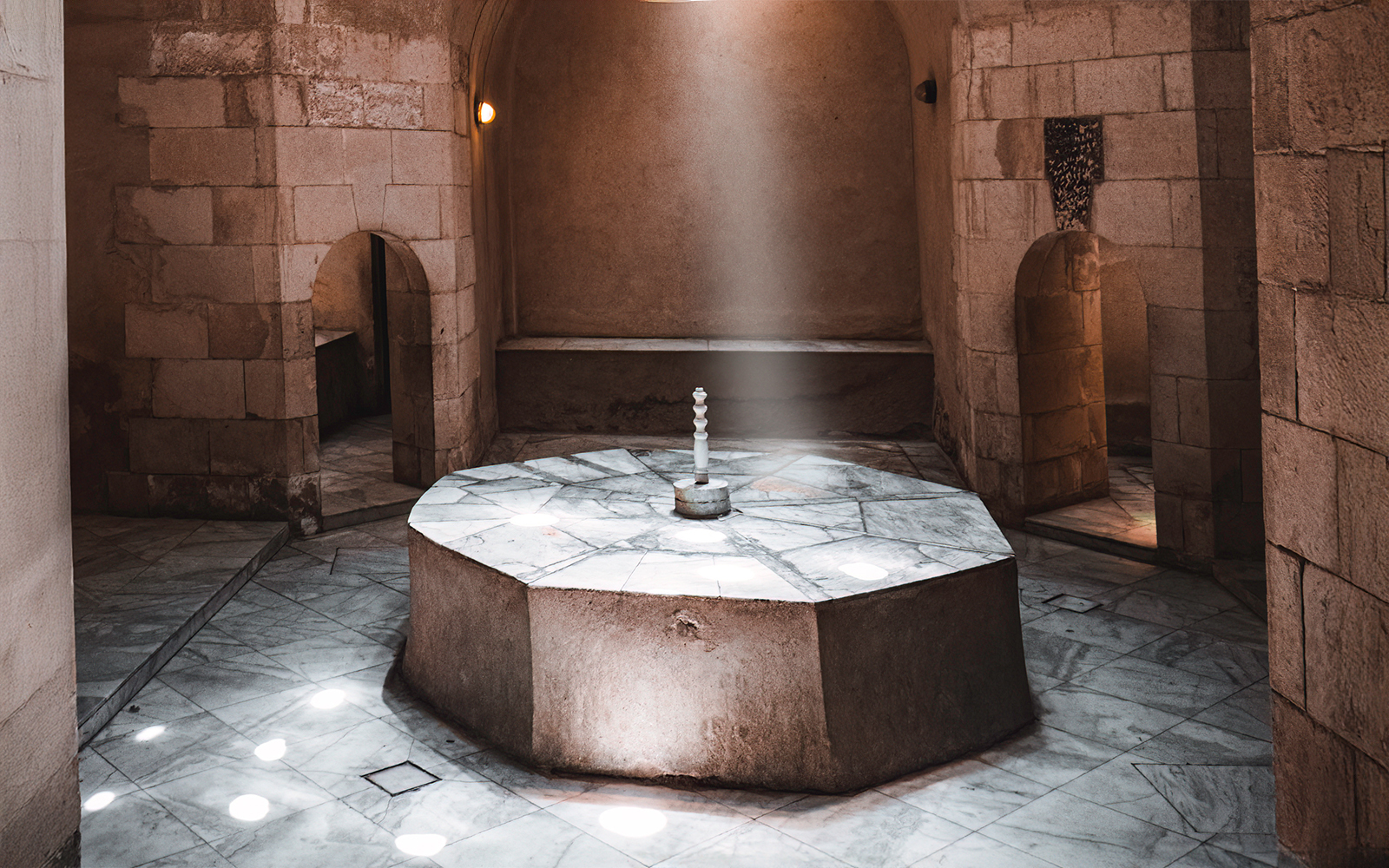 Traditional Turkish hammam interior with marble basins and domed ceiling in Istanbul.