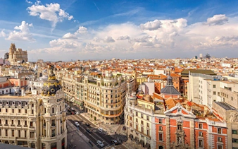 Aerial view of Madrid's Gran Vía, featuring historic architecture and bustling streets.