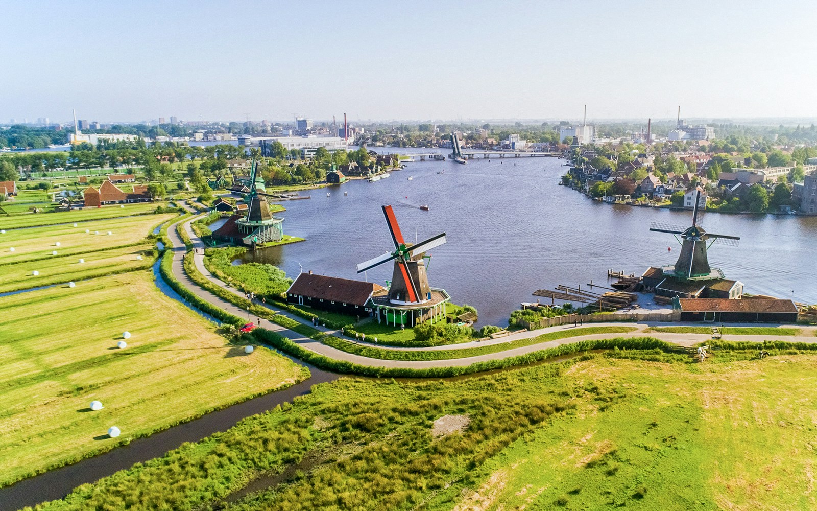 Aerial view of Zaanse Schans windmills by the river near Amsterdam.