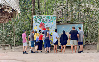 Tour group examining maps at Cu Chi Tunnels, Vietnam.