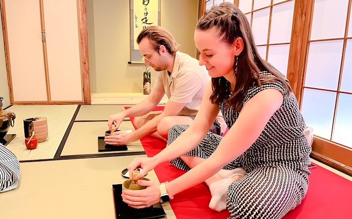 Couple enjoying a traditional tea ceremony in Osaka Dotonbori.
