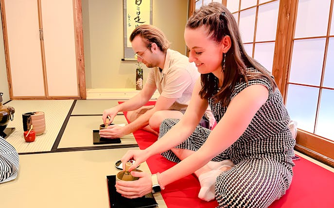Couple enjoying a traditional tea ceremony in Osaka Dotonbori.