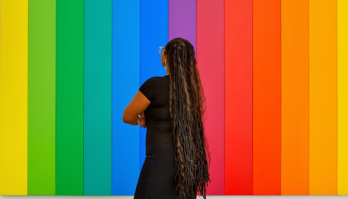 Woman observing modern art piece at MoMA, New York City.