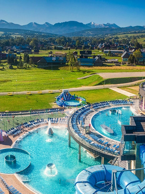 Chocholow Thermal Baths with pools and slides, surrounded by scenic mountain views.