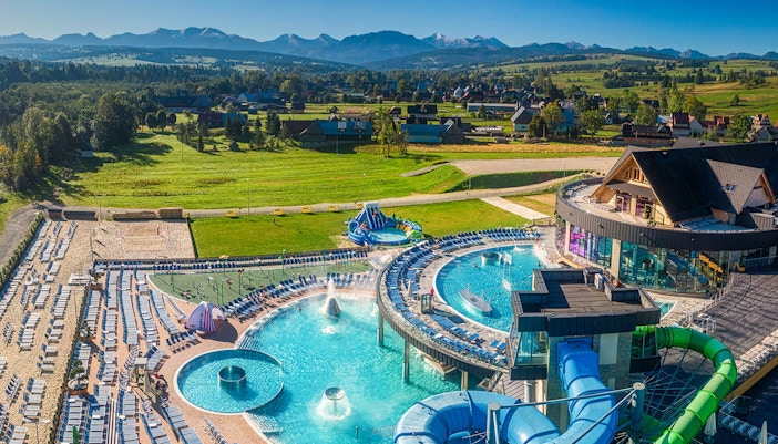Chocholow Thermal Baths with pools and slides, surrounded by scenic mountain views.