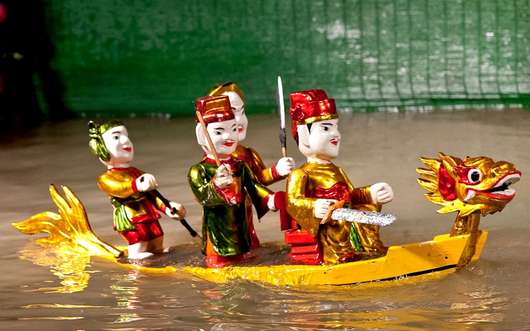 Water puppets on a dragon boat at Golden Water Puppet Show, Vietnam.